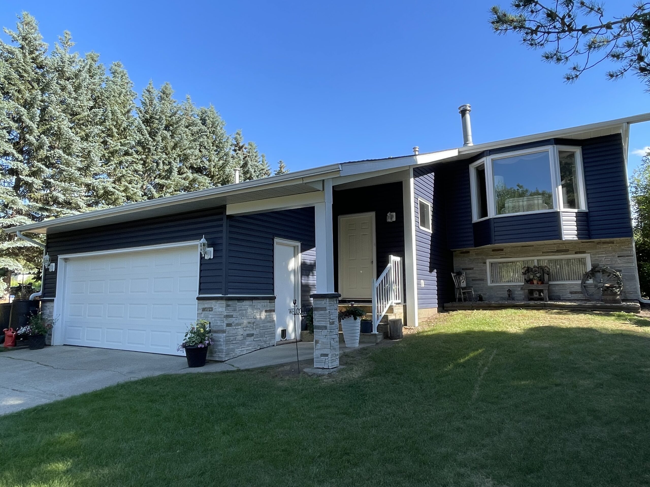 Mission Point Versetta Stone & Marine Blue Vinyl Siding in Parkland County