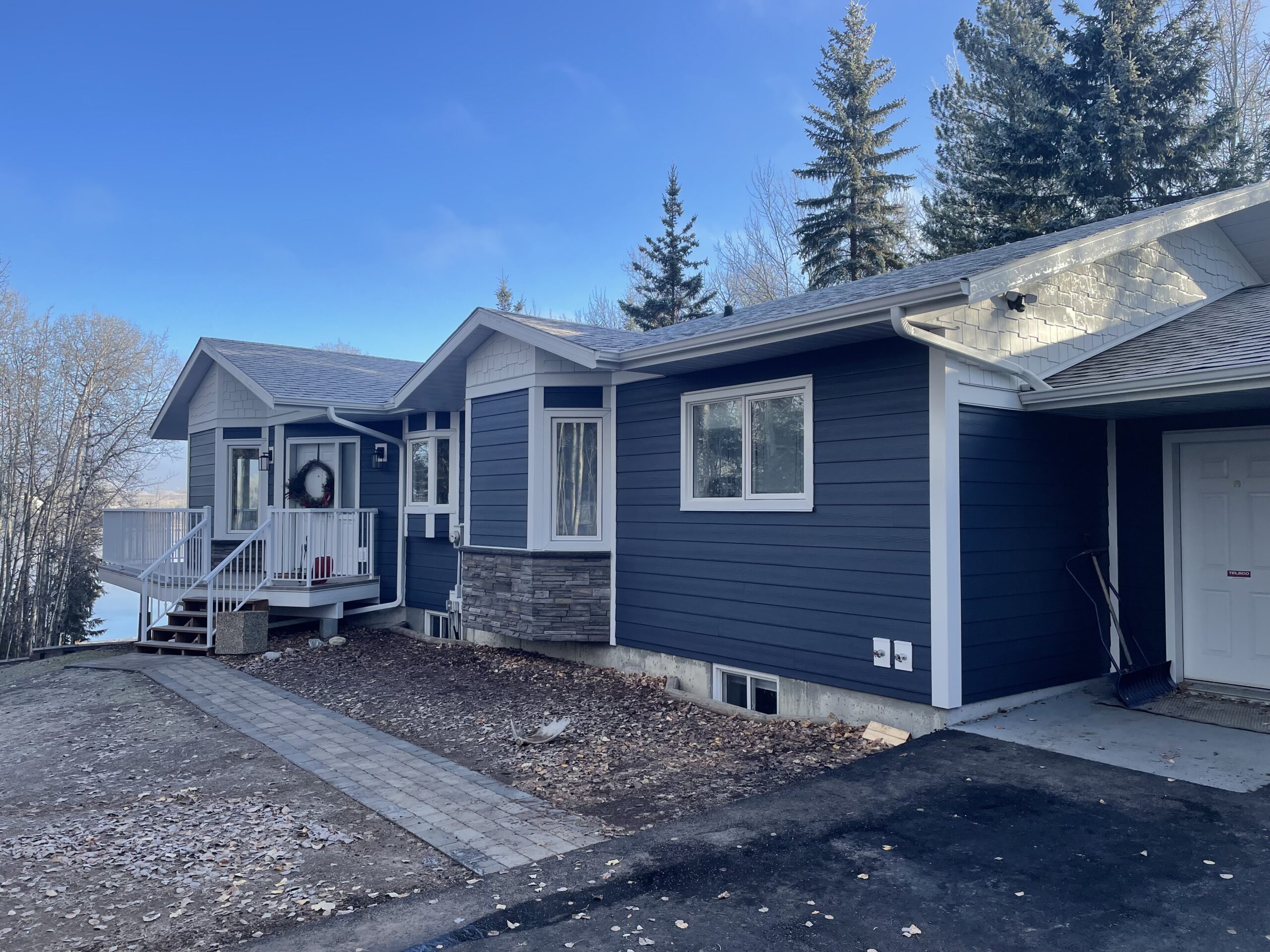 Sterling Versetta Stone with Deep Ocean Blue Hardie Plank Siding in Parkland County