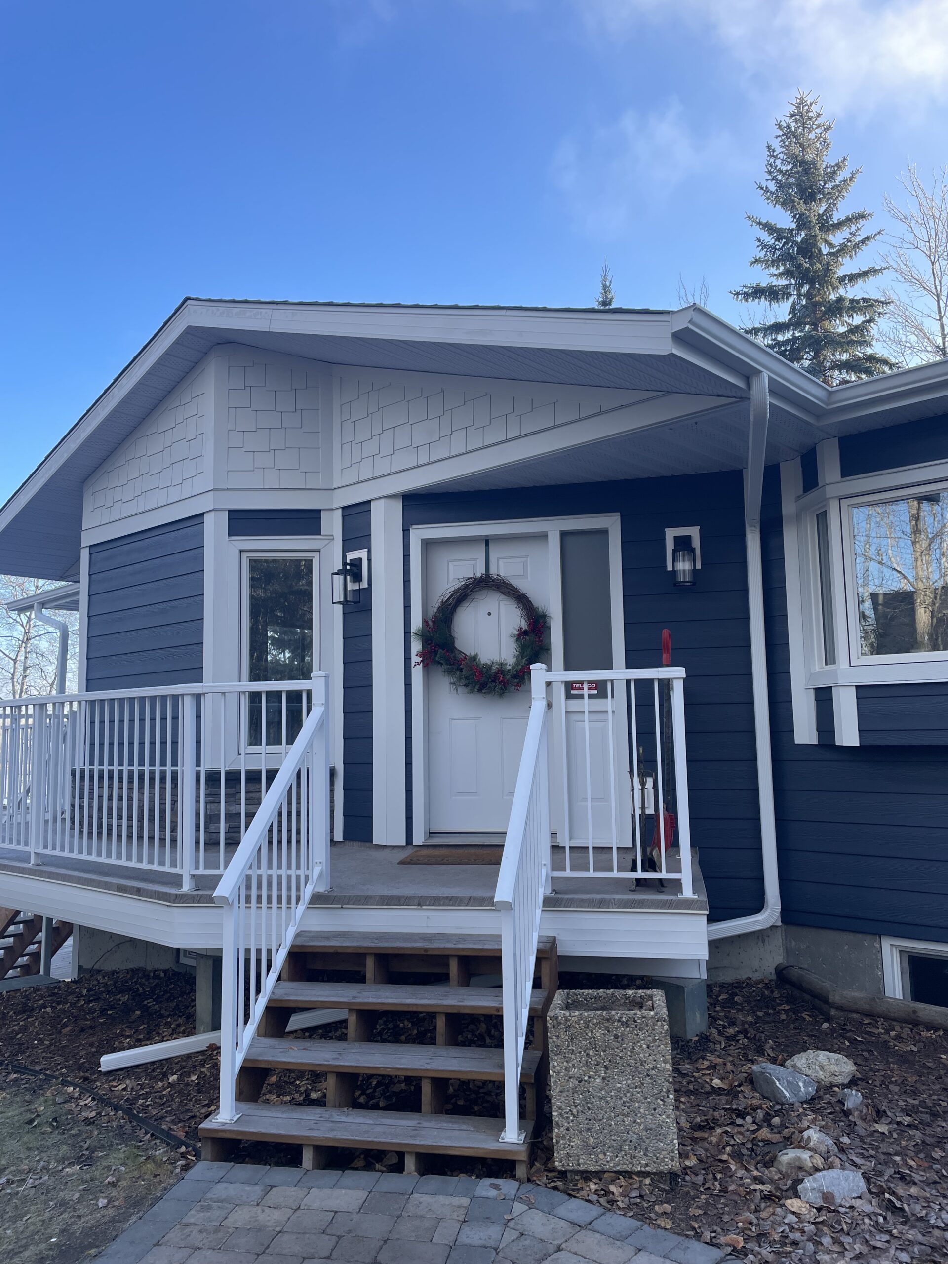 Sterling Versetta Stone with Deep Ocean Blue Hardie Plank Siding in Parkland County